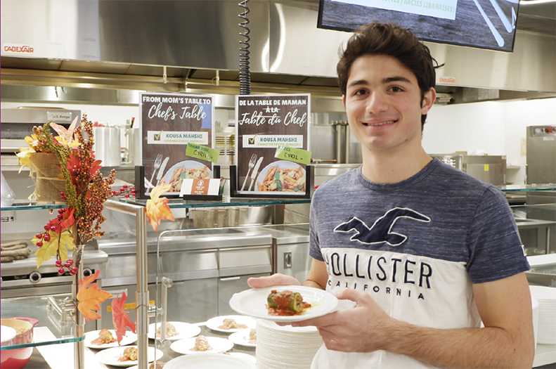 resident standing with their plate of food